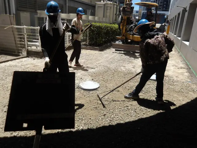 路盤の不陸整正 レーキで平坦性を確保する作業状況